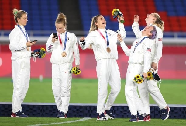 Bronze medalist Megan Rapinoe and teammates of Team United States celebrate with their bronze medals during the Women's Football Competition Medal...