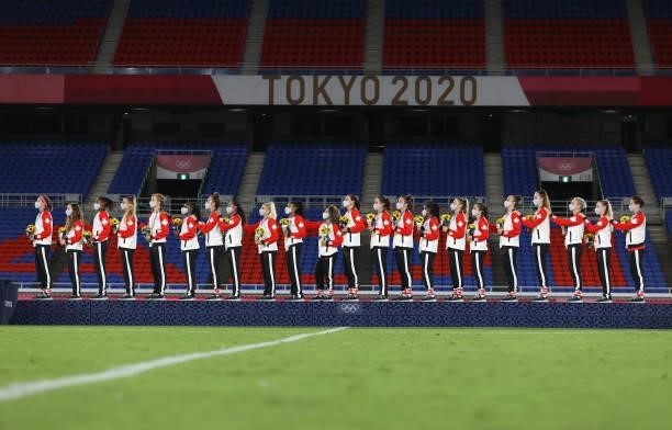 Gold Medalists of Team Canada stand with their gold medals on the podium during the Women's Football Competition Medal Ceremony on day fourteen of...
