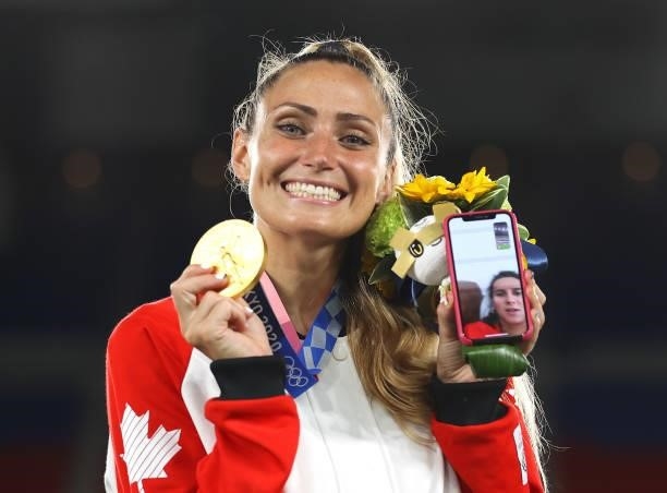 Gold medalist Shelina Zadorsky of Team Canada reacts on the phone with her gold medal during the Women's Football Competition Medal Ceremony on day...
