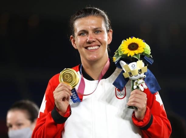 Gold medalist Christine Sinclair of Team Canada poses with their gold medal during the Women's Football Competition Medal Ceremony on day fourteen of...