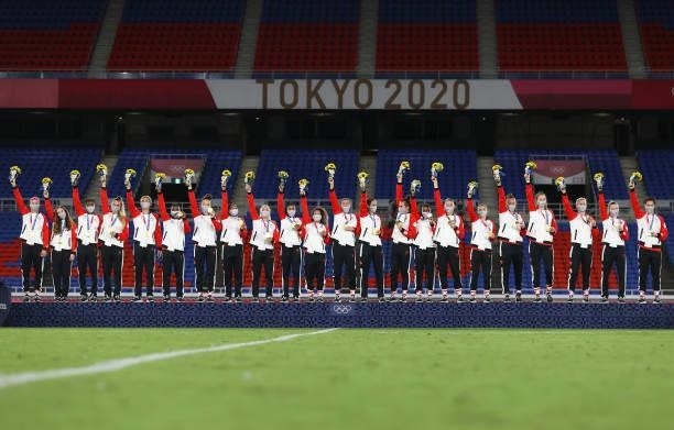 Gold Medalists of Team Canada celebrate with their gold medals on the podium during the Women's Football Competition Medal Ceremony on day fourteen...