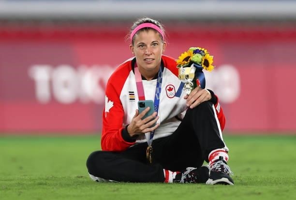 Gold medalist Stephanie Labbe of Team Canada poses with her gold medal whilst on the phone during the Women's Football Competition Medal Ceremony on...