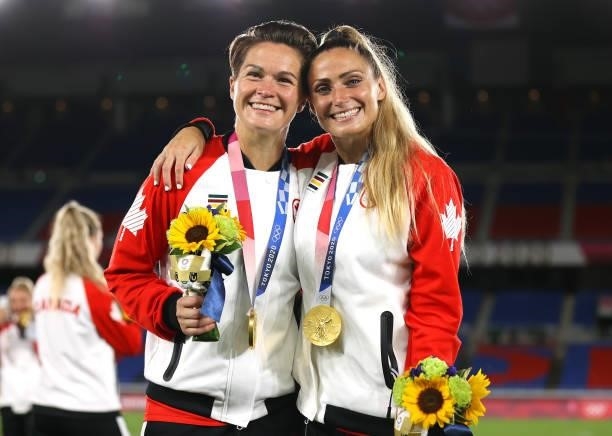 Gold medalists Erin McLeod and Shelina Zadorsky of Team Canada pose with their gold medals during the Women's Football Competition Medal Ceremony on...