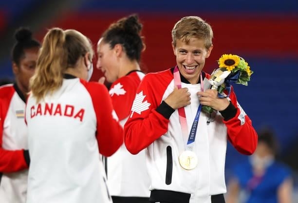 Gold medalist Quinn of Team Canada reacts with their gold medal during the Women's Football Competition Medal Ceremony on day fourteen of the Tokyo...