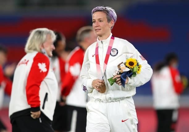 Bronze medalist Megan Rapinoe of Team United States reacts with their bronze medal during the Women's Football Competition Medal Ceremony on day...