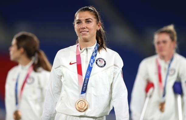 Bronze medalist Alex Morgan of Team United States reacts with their bronze medal during the Women's Football Competition Medal Ceremony on day...