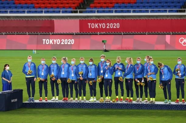 Silver medalists of Team Sweden celebrate with their silver medals on the podium during the Women's Football Competition Medal Ceremony on day...