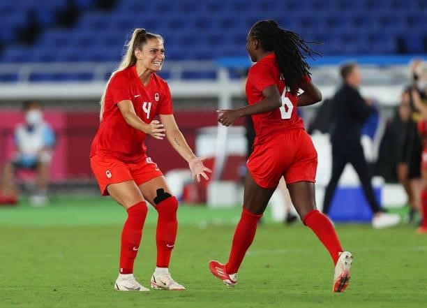 Shelina Zadorsky of Team Canada celebrates with Deanne Rose of Team Canada during the penalty shoot out during the Women's Gold Medal Match between...