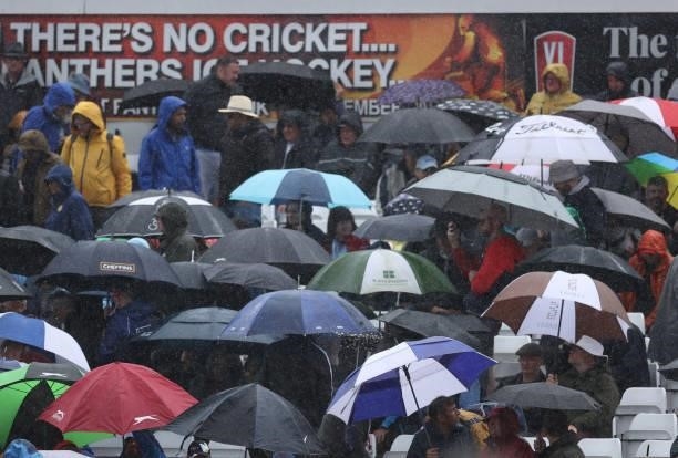 Spectators shield from the rain during day three of the First LV= Insurance test match between England and India at Trent Bridge on August 05, 2021...