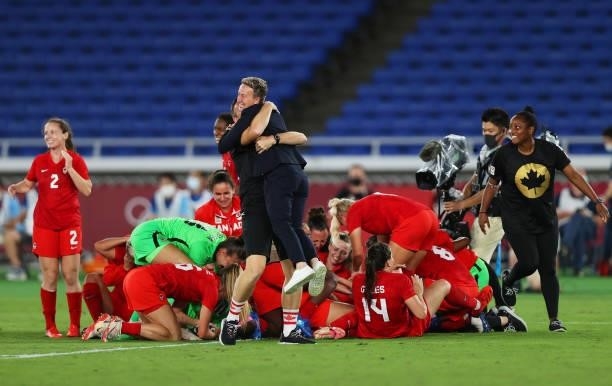 Beverly Priestman, Head Coach celebrates following their team's victory in the penalty shoot out after the Women's Gold Medal Match between Canada...