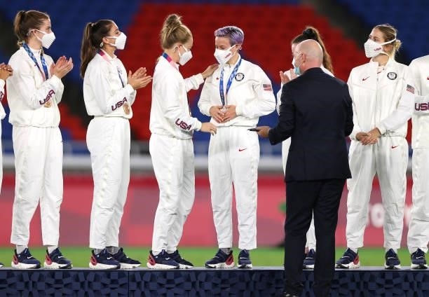 Bronze medalist Megan Rapinoe reacts as they are awarded their medal during the Women's Football Competition Medal Ceremony on day fourteen of the...