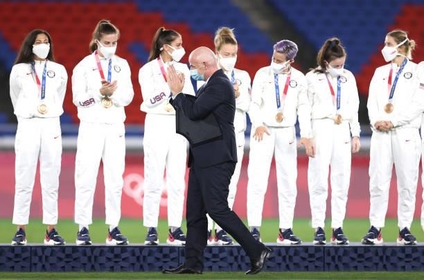 Gianni Infantino, President of FIFA applauds as he walks past bronze medalists Team United States during the Women's Football Competition Medal...