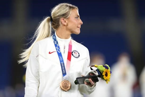Bronze medalist Julie Ertz of Team United States reacts with their bronze medal during the Women's Football Competition Medal Ceremony on day...