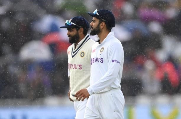 India captain Virat Kohli leaves the field when rain stops play in the final session during day three of the First Test Match between England and...