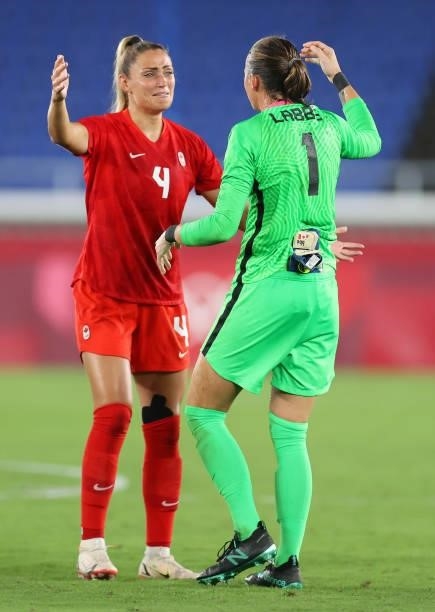 Shelina Zadorsky and Stephanie Labbe of Team Canada celebrate their team's victory after winning in the penalty shootout during the Women's Gold...