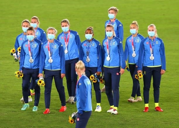 Silver medalists Team Sweden look on after receiving their silver medals during the Women's Football Competition Medal Ceremony on day fourteen of...