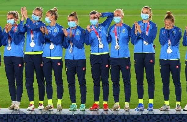 Silver medalists Team Sweden stand on the podium after receiving their silver medals during the Women's Football Competition Medal Ceremony on day...