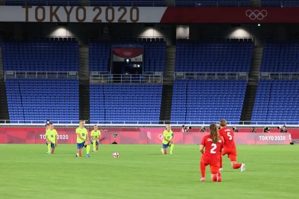 Team Sweden and Team Canada kneel before the women's football gold medal match on day fourteen of the Tokyo 2020 Olympic Games at International...