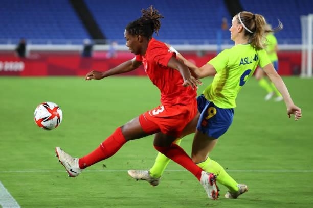 Kadeisha Buchanan of Team Canada and Kosovare Asllani of Team Sweden battle for possession during the first half during the women's football gold...