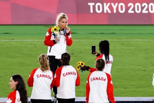 Players of Canada celebrate after the Olympic women's football gold medal match between Sweden and Canada at International Stadium Yokohama on August...