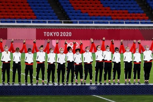 Players of Canada attend the award ceremony of the Olympic women's football gold medal match between Sweden and Canada at International Stadium...