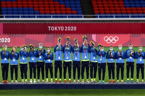 Players of Sweden attend the award ceremony of the Olympic women's football gold medal match between Sweden and Canada at International Stadium...