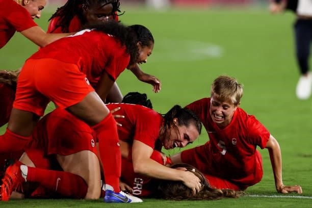 Julia Grosso of Canada celebrate the victory with teammates after the penalty shot out of the Olympic women's football gold medal match between...