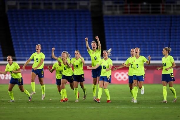 Players of Sweden cheer during the penalty shot out of the Olympic women's football gold medal match between Sweden and Canada at International...
