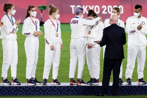 Players of United States attend the award ceremony of the Olympic women's football gold medal match between Sweden and Canada at International...