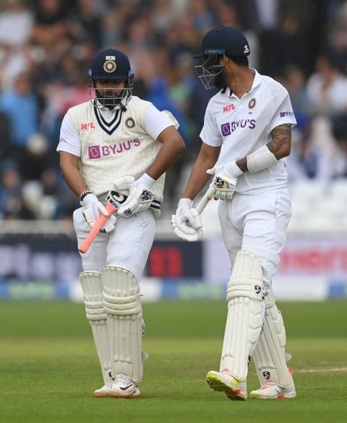 Rishabh Pant and KL Rahul of India protect their bats as they walk off as it rains during the third day of the 1st LV= Test match between England and...