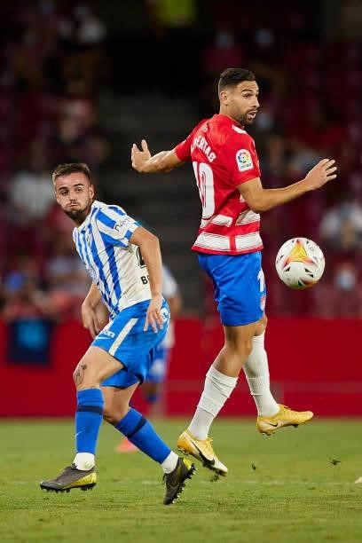Antonio Puertas of Granada CF and Ismael Casas of Malaga CF battle for the ball during the Ciudad de Granada trophy match between Granada CF and...