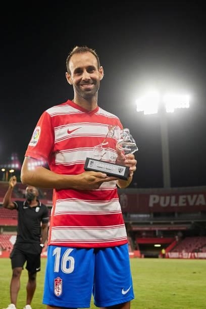 Victor Diaz of Granada CF poses with the trophy after the Ciudad de Granada trophy match between Granada CF and Malaga CF at Nuevo Los Carmenes...
