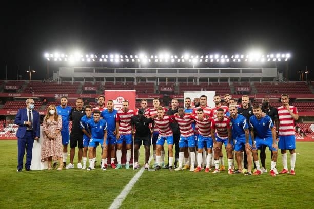 Granada CF team pose with the trophy after the Ciudad de Granada trophy match between Granada CF and Malaga CF at Nuevo Los Carmenes Stadium on...