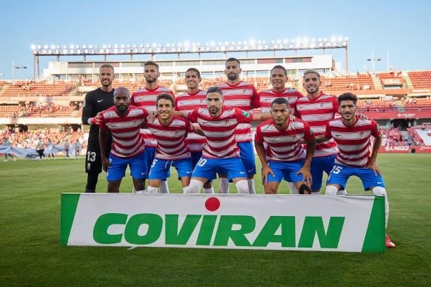 Players of Granada line up for a team photo prior to the Ciudad de Granada trophy match between Granada CF and Malaga CF at Nuevo Los Carmenes...