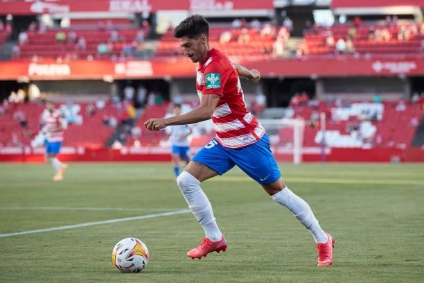 Carlos Neva of Granada CF runs with the ball during the Ciudad de Granada trophy match between Granada CF and Malaga CF at Nuevo Los Carmenes Stadium...