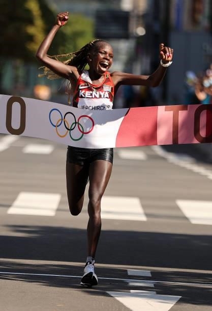 Peres Jepchirchir of Team Kenya celebrates as she crosses the finish line to win the gold medal in the Women's Marathon Final on day fifteen of the...