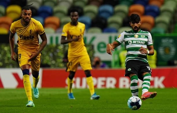 Ricardo Esgaio of Sporting CP kicks the ball challenged by Cassiano of FC Vizela in action during the Liga Bwin match between Sporting CP and FC...