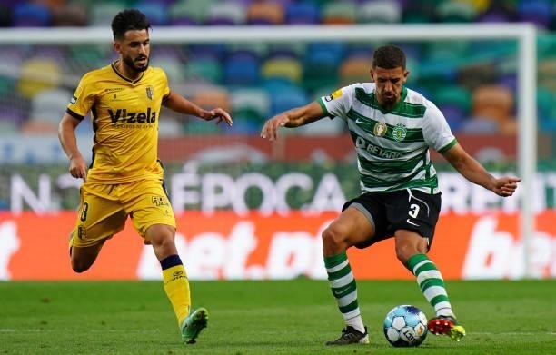 Zouhair Feddal of Sporting CP is challenged by Raphael Guzzo of FC Vizela in action during the Liga Bwin match between Sporting CP and FC Vizela at...