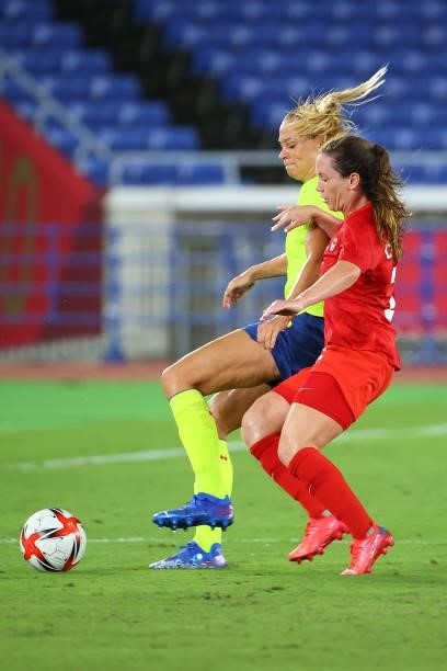 Fridolina Rolfo of Team Sweden and Allysha Chapman of Team Canada battle for possession in the first half during the women's football gold medal...