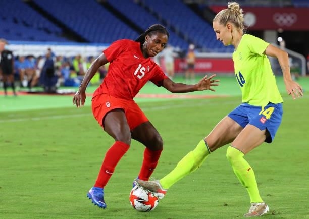 Ashley Lawrence of Team Canada and Nathalie Bjorn of Team Sweden battle for possession in the second half during the women's football gold medal...