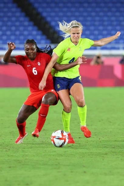 Deanne Rose of Team Canada and Hanna Glas of Team Sweden batle for possession in the first period of extra time during the women's football gold...