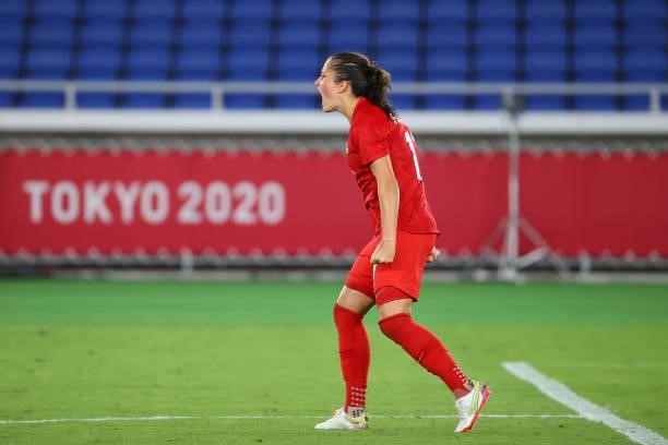 Jessie Fleming of Team Canada celebrates after making her shot during the penalty kick shoot-out during the women's football gold medal match between...