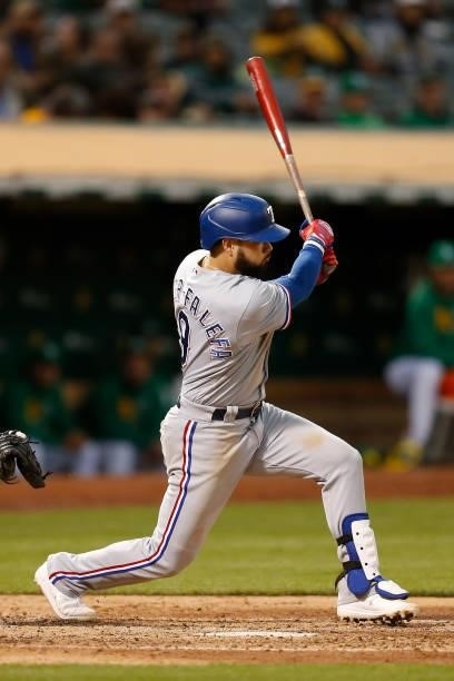 Isiah Kiner-Falefa of the Texas Rangers hits an RBI single in the top of the fifth inning against the Oakland Athletics at RingCentral Coliseum on...