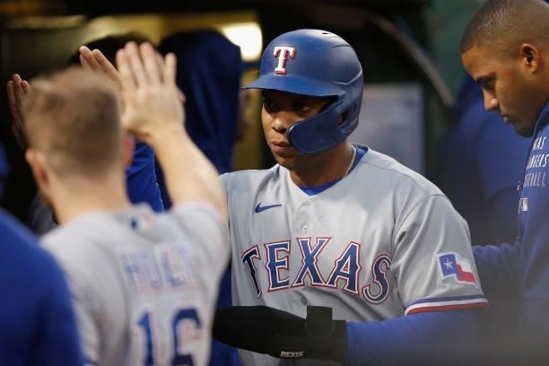 Curtis Terry of the Texas Rangers celebrates in the dugout after scoring on a single by Isiah Kiner-Falefa in the top of the fifth inning against the...
