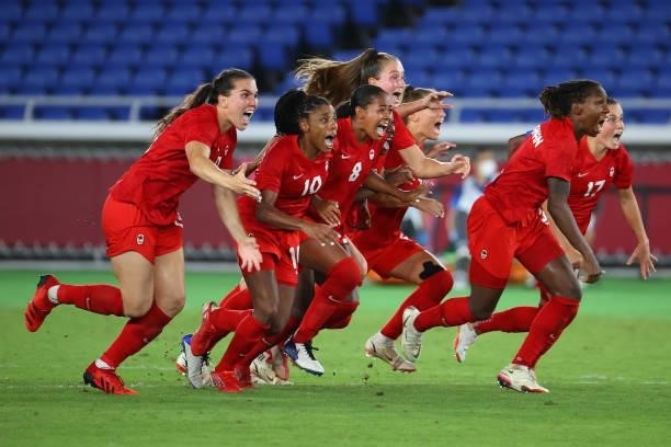 Team Canada celebrates after defeating Team Sweden in penalties to win gold the women's football gold medal match between Canada and Sweden on day...