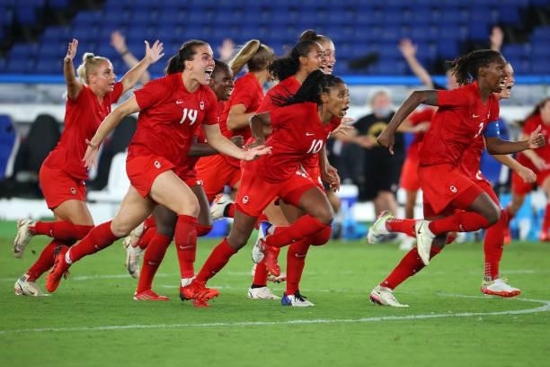 Team Canada celebrates after defeating Team Sweden in penalties to win gold the women's football gold medal match between Canada and Sweden on day...