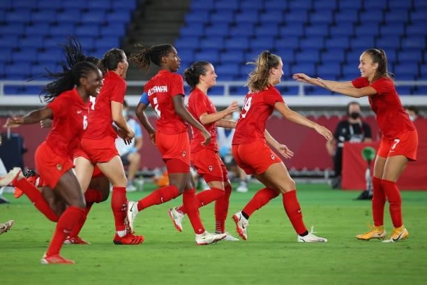 Julia Grosso of Team Canada celebrates with teammates after scoring the game-winning goal during the penalty kick shoot-out to win the women's...
