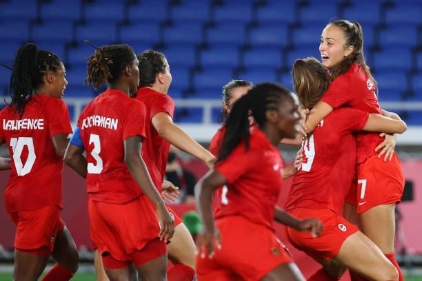 Julia Grosso of Team Canada celebrates with teammates after scoring the game-winning goal during the penalty kick shoot-out to win the women's...
