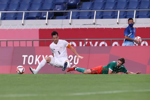 Sebastian Cordova of Team Mexico is blocked by Maya Yoshida of Team Japan in the Men's Bronze Medal Match between Mexico and Japan on day fourteen of...