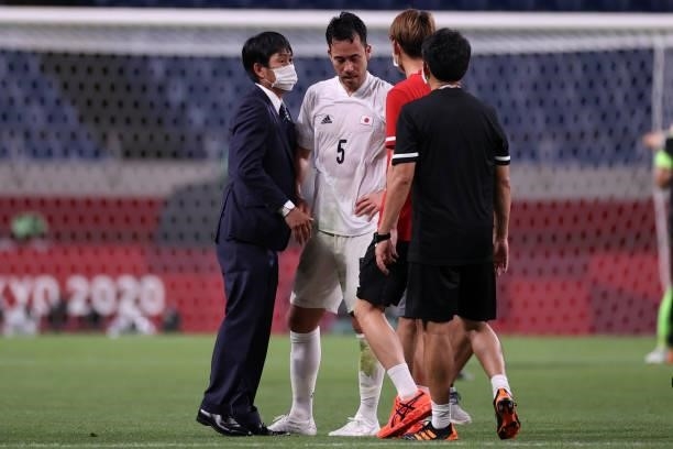 Maya Yoshida of Team Japan is consoled by Hajime Moriyasu, Head Coach of Team Japan following defeat in the Men's Bronze Medal Match between Mexico...